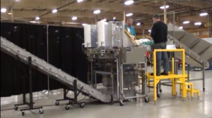 A DynaCon conveyor being used for automatically bagging commercial laundry 