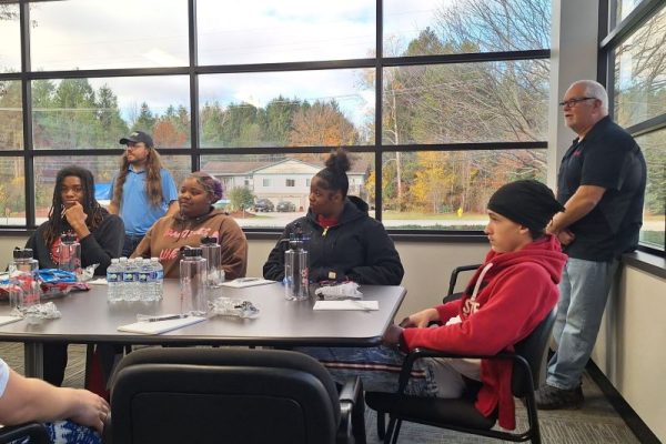 students sitting at Dynamic Conveyor conference table for Manufacturing Week