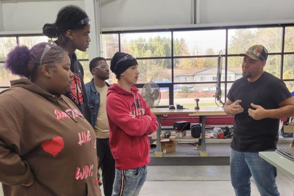 group of students learning from a dynamic conveyor employee