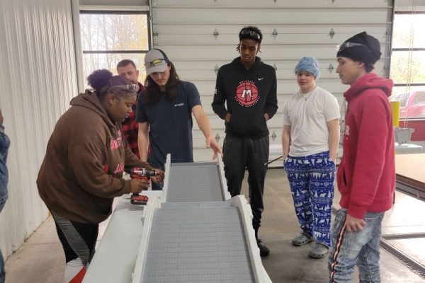 students getting hands on conveyor manufacturing learning